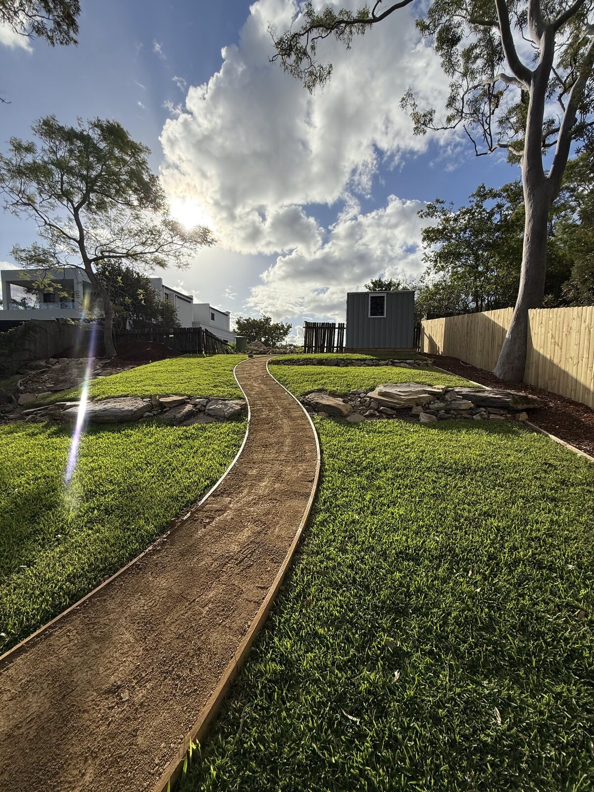 Curved garden path through new turf