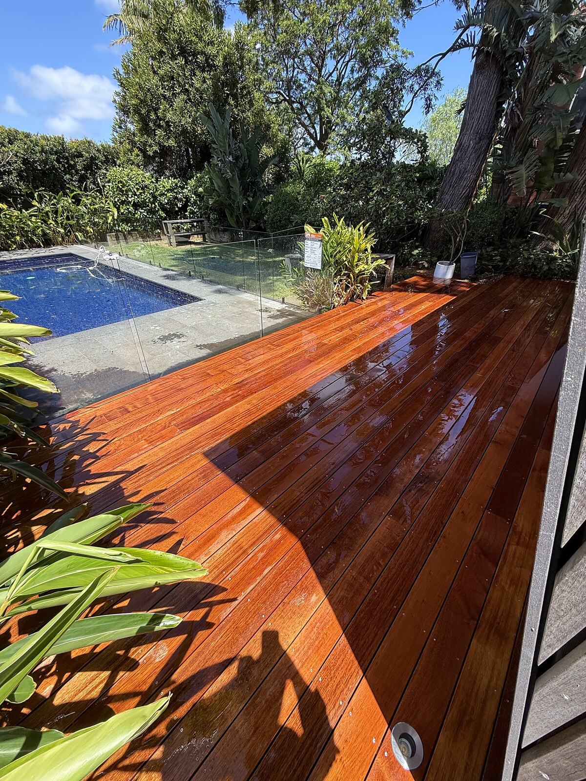 Hardwood deck beside a pool